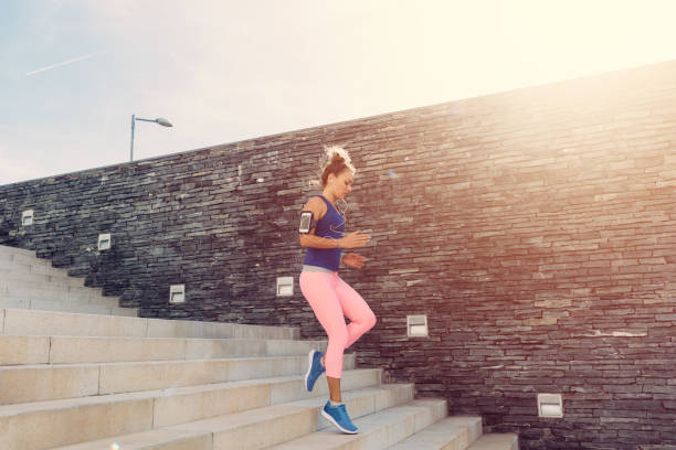 istock Sportswoman jogging downstairs 689320424