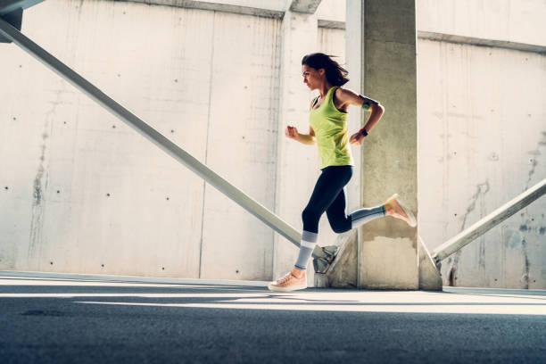 istock Sportswoman jogging outside 689320540