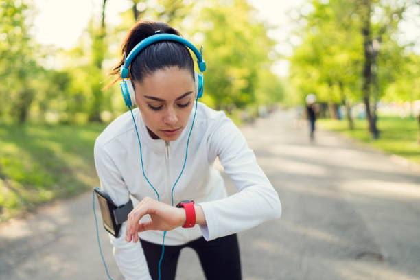 istock Sportswoman checking pulse on smart watch 689320622
