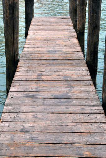 Typical and aged wooden pier in Venice. Italy