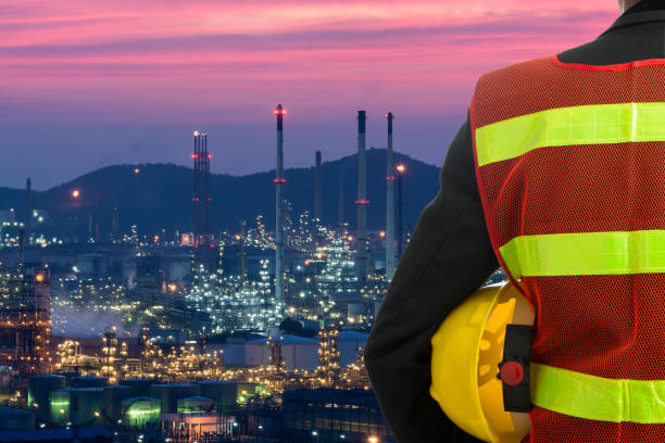 istock Hand or arm of engineer hold yellow plastic helmet 689323890