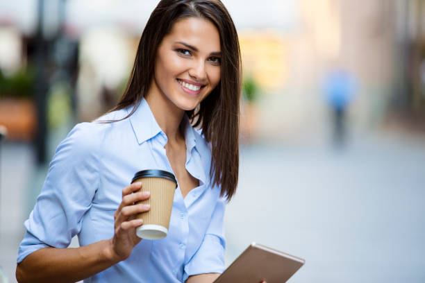 istock Smart beautiful girl holding cup of coffee 689324812