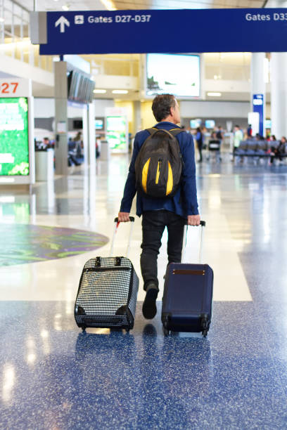 istock Active Senior with Backpack and Two Suitcases in Airpot 689333842