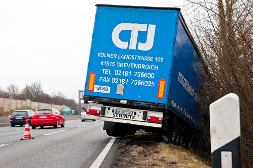 Highway A66 Exit 40 Langenselbold, Germany - February 24, 2012: Semi truck left the right lane of highway and entered the ditch. There were no other vehicles involved with the accident, the driver remained uninjured.