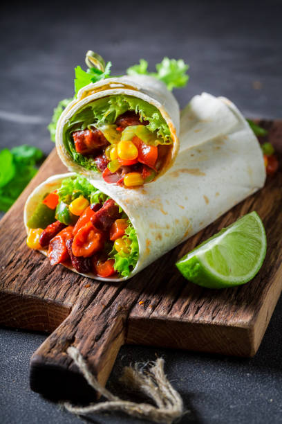 istock Enjoy your burrito with red salsa, lettuce and vegetables 689334394