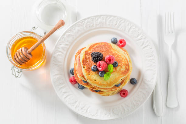 istock Yummy american pancakes with blueberries and raspberries 689335104