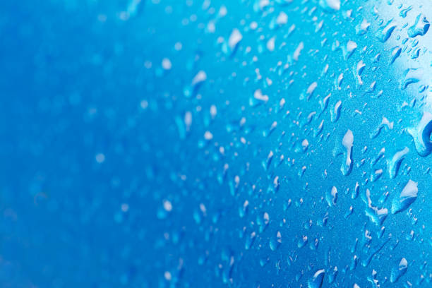 abstract water drops on blue background selective focus stock photo