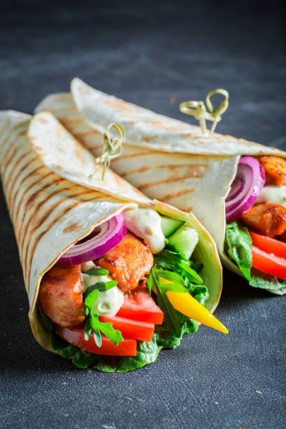 istock Enjoy your grilled tortilla with chicken, tomatoes and lettuce 689337880