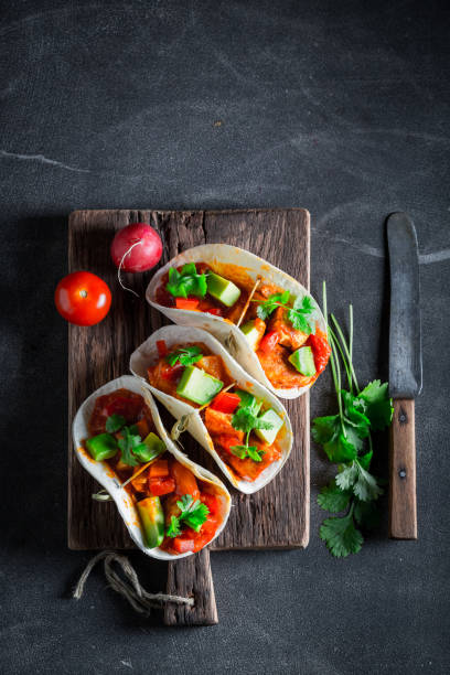 istock Delicious tacos with spicy chicken and fresh vegetables 689338376