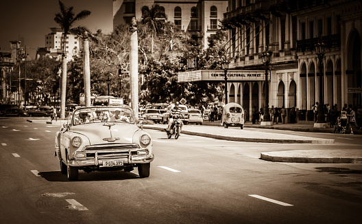 Havana: HDR - American Cabriolet vintage car drives with tourists on the main street in Havana Cuba - Retro Serie SEPIA Cuba Reportage