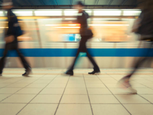 istock Subway train leaving station with people on platform. 689347038