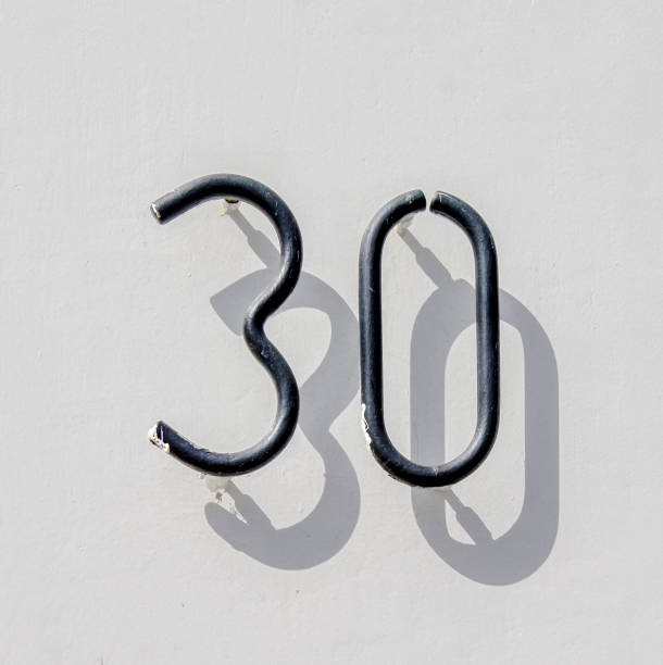 No. 30 house number thirty, made out of a bent steel rod. Black lettering against a white background. hook of holland stock pictures, royalty-free photos & images