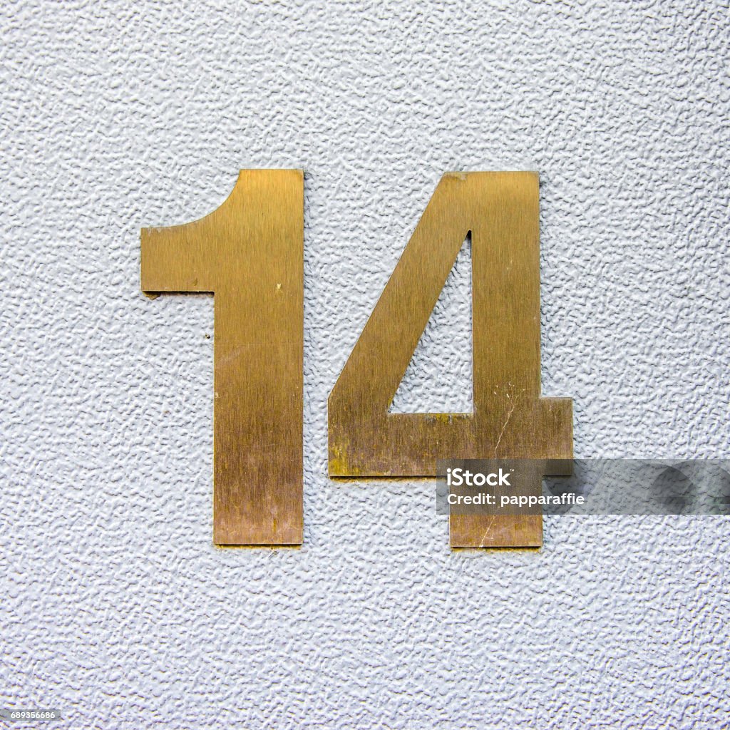 No. 14 House number fourteen cut out of brass. Number Stock Photo