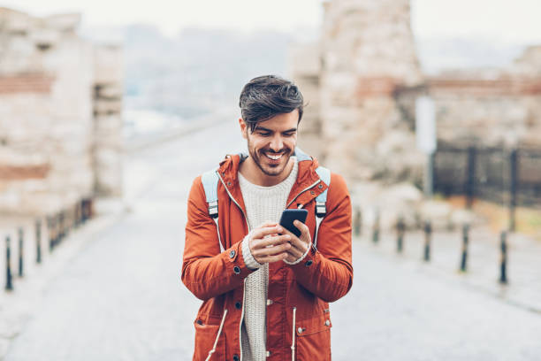 istock Tourist using smart phone GPS in an old town 689366702