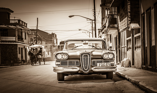 Santa Clara: HDR - American red Ford Edsel classic car with white roof parked on the side street in Santa Clara Cuba - Retro Serie SEPIA Cuba Reportage