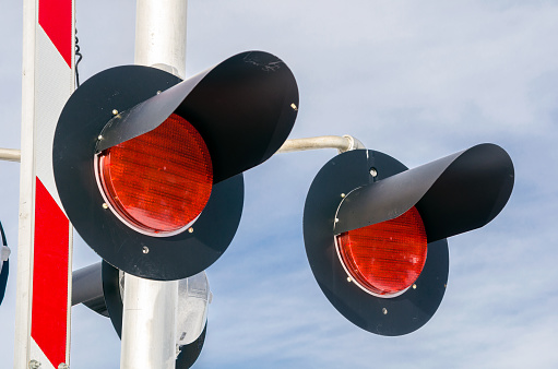 Close up of Signals at a Railroad Crossing with Cloudy Sky in Background