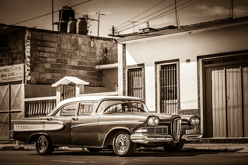 Santa Clara: HDR - American red Ford Edsel classic car with white roof parked on the side street in Santa Clara Cuba - Retro Serie SEPIA Cuba Reportage