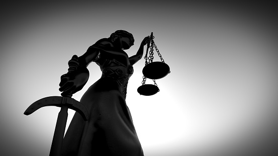 Themis with scale and sword. Justice and law symbol statue