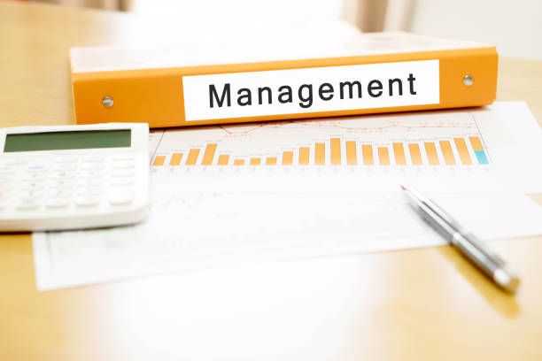 istock Orange  binder on desk in the office with calculator and pen 689386164