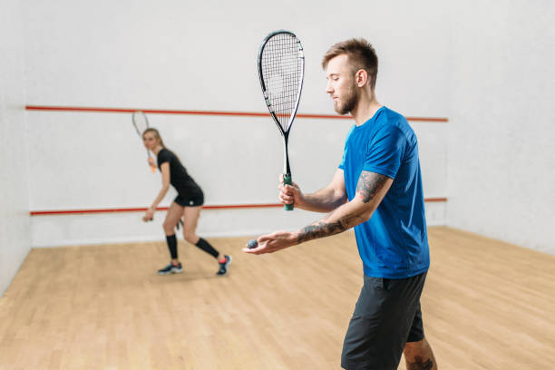 istock Couple with squash rackets, indoor training club 689386612