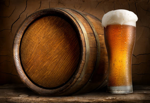 Beer in cask and glass Beer in cask and glass on wooden table ale stock pictures, royalty-free photos & images