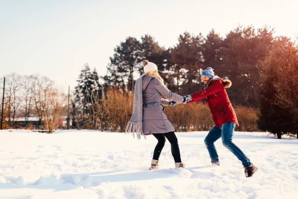 istock Mid Adult Couple Having Fun Outdoors At Winter 689399034