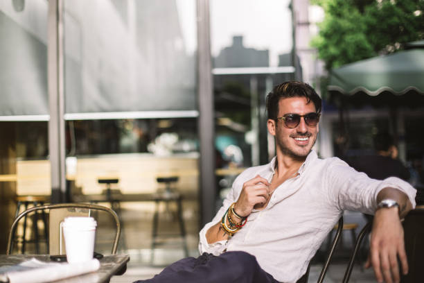 istock Elegant man relaxing in cafe 689404404