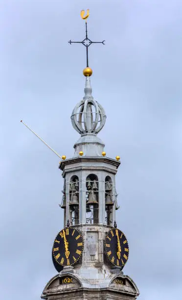 Munttoren Bell Tower Clock Golden Rooster Windvane Singel Canal Amsterdam Holland Netherlands.  Munttoren tower is part of the old Amsterdam City Wall
