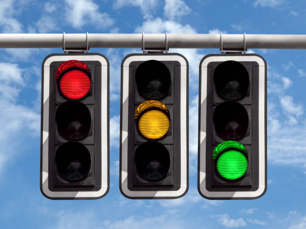 Traffic lights - red yellow green against sky Three traffic lights against blue sky background kazakhstan photos stock pictures, royalty-free photos & images