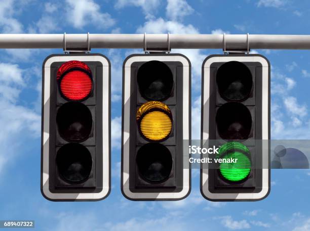 Traffic Lights Red Yellow Green Against Sky Stock Photo - Download Image Now - Stoplight, Red, Green Color