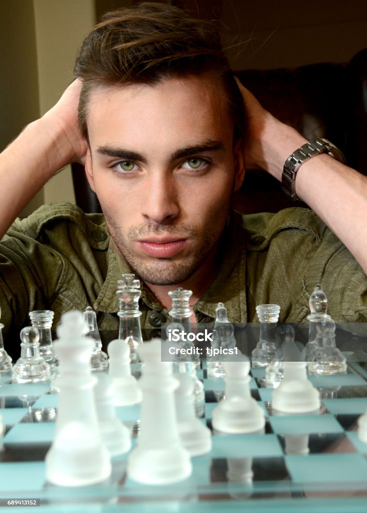 Handsome Male Model Considers His Next Chess Move Stock Photo - Download  Image Now - Chess, Chess Piece, Contemplation - iStock