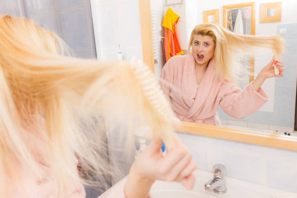 istock Shocked woman wearing dressing gown brushing her hair 689422512
