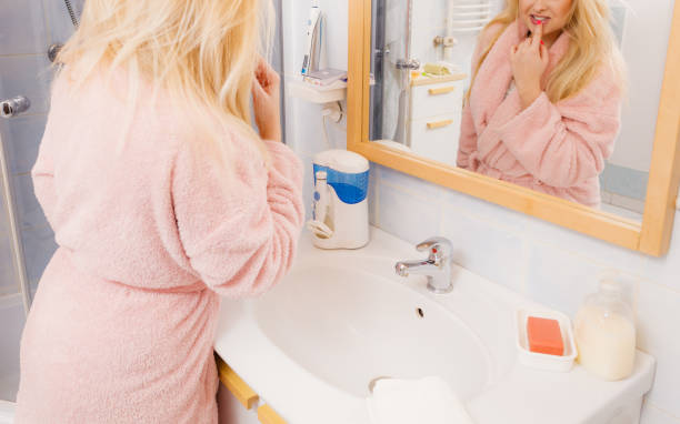 istock Woman looking at her reflection in mirror 689425406