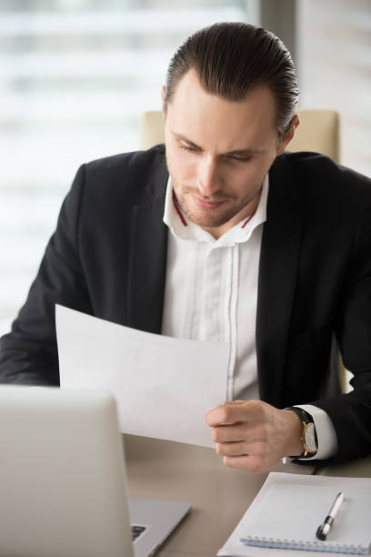 istock Male entrepreneur reading correspondence 689425480