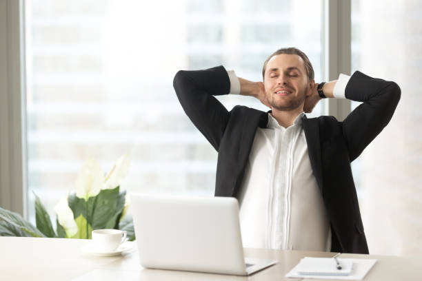 istock Satisfied businessman relaxing at workplace 689425540