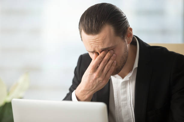 istock Businessman suffering from eyes fatigue at work 689425600