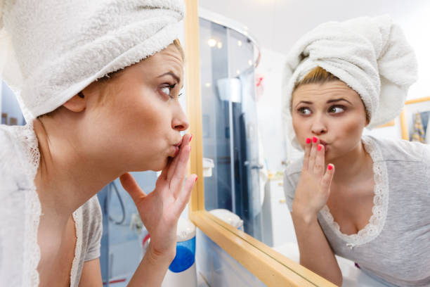 istock Woman looking at her reflection in mirror 689428426