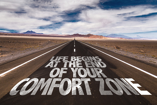 Life Begins at the End of your Comfort Zone written on desert road sign
