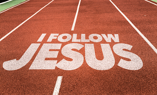 I Follow Jesus written on running track