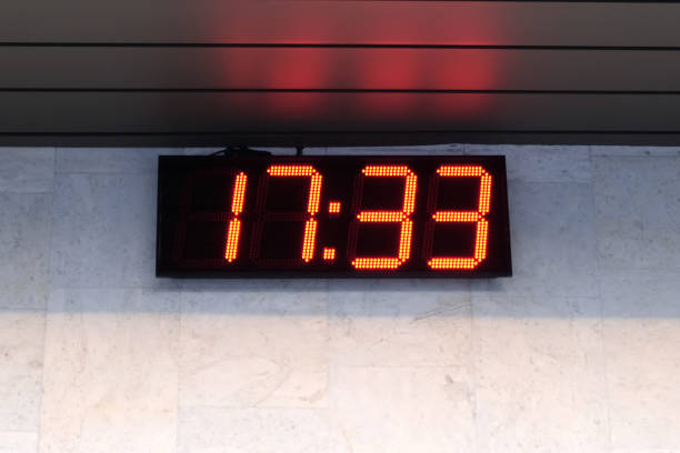 istock Electronic clock on the wall of the building show time 689444834