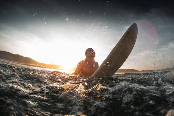 istock Youn happy man moves throung breaking waves 689450684