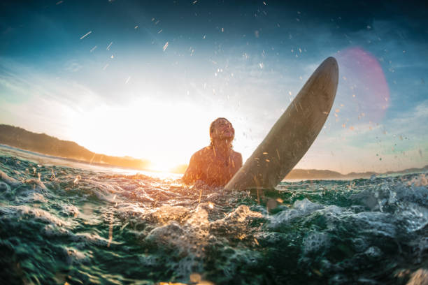istock Youn happy man moves throung breaking waves 689450736