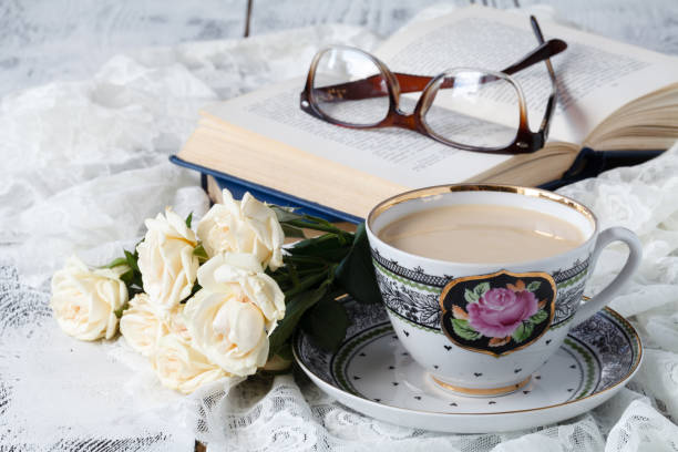 istock Cup of tea with notebook and glasses on wooden table 689453510