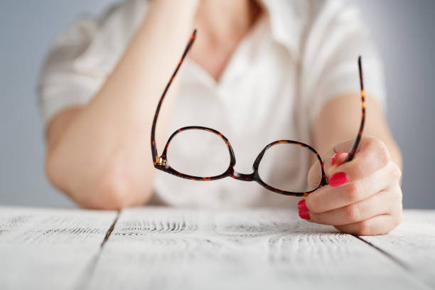istock female hand holding a brown framed glasses 689462350