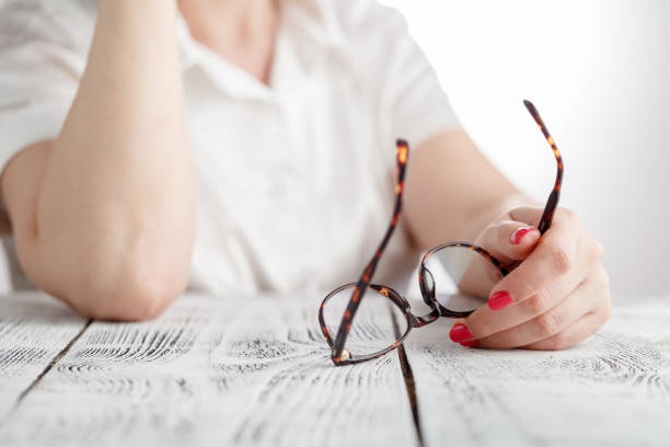 istock Surprised businesswoman taking off glasses while reading in office 689466086
