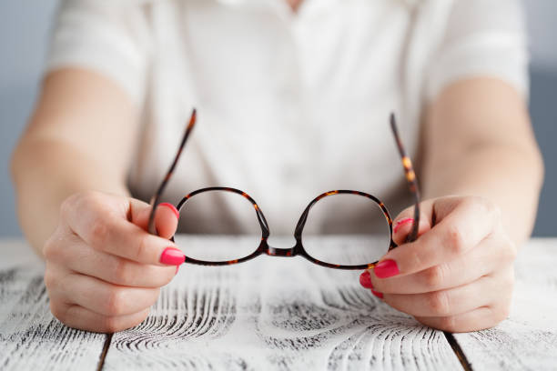istock woman holding glasses on a white background 689468574