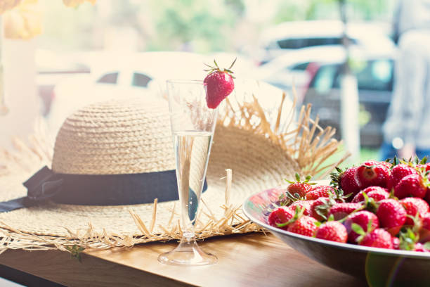 istock Dish with strawberries and champagne glasses on the table. 689475098