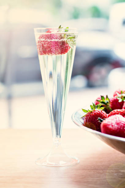 istock Dish with strawberries and champagne glasses on the table. 689477958