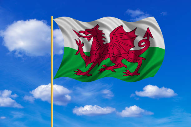 istock Flag of Wales waving on blue sky background 689481768