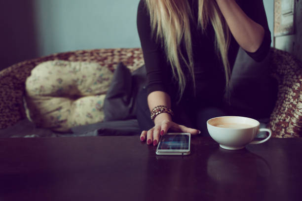 Drink morning coffee and reading text message during work in comfortable coffee shop